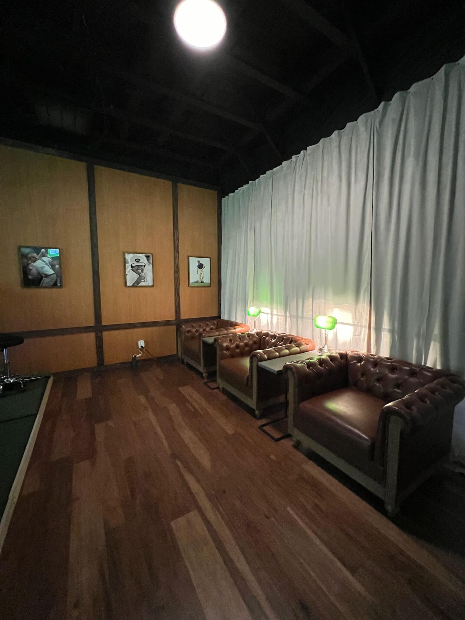 Leather lounge seating inside The Clubhouse AZ indoor golf studio in Phoenix